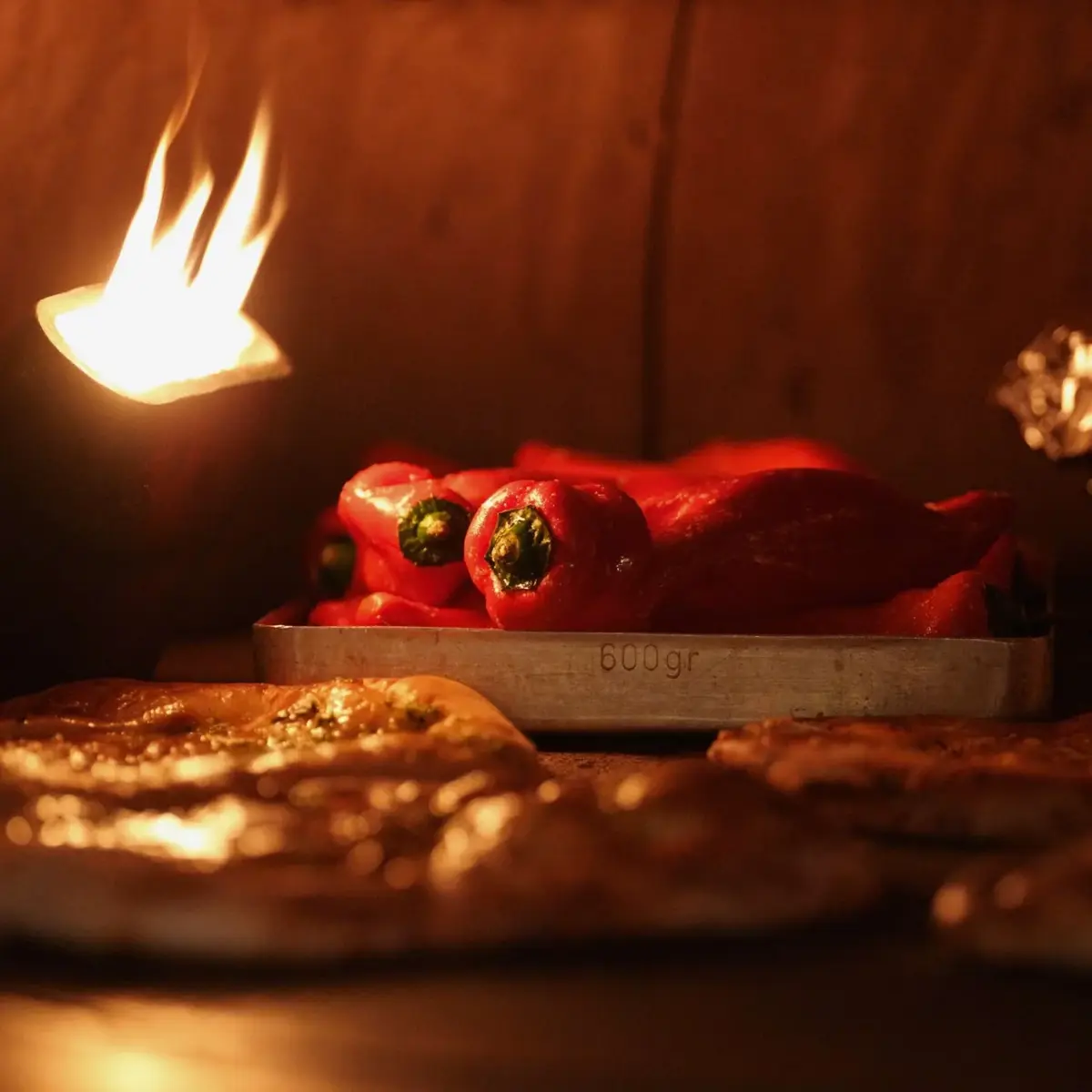 Flatbreads and red peppers baking over the flames in the oven at Bistro 1